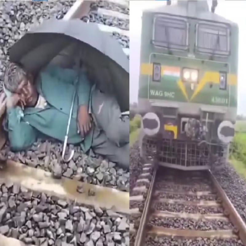 man-sleeps-under-umbrella-on-railway-track